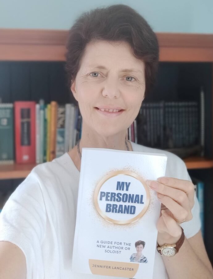 Writing coach Jennifer holding a book