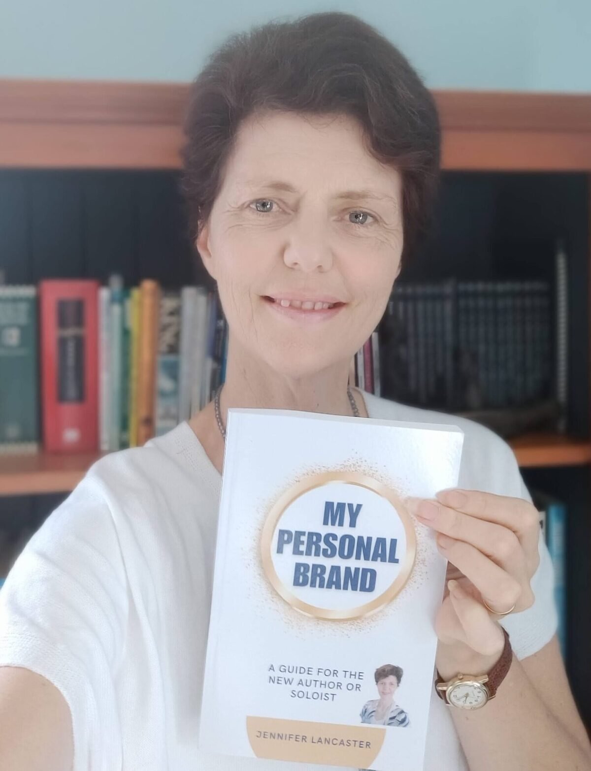 Business Publisher Jennifer holding a personal brand book